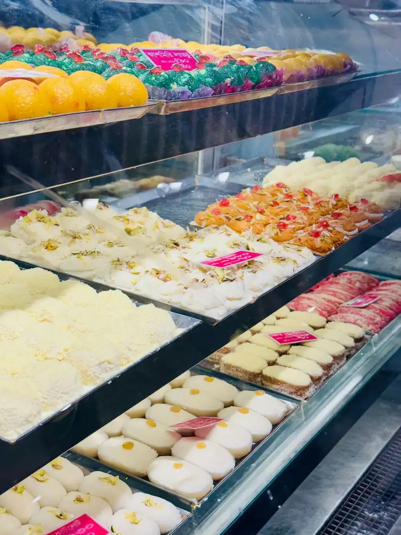 Colourful Indian sweets arranged in the shop display