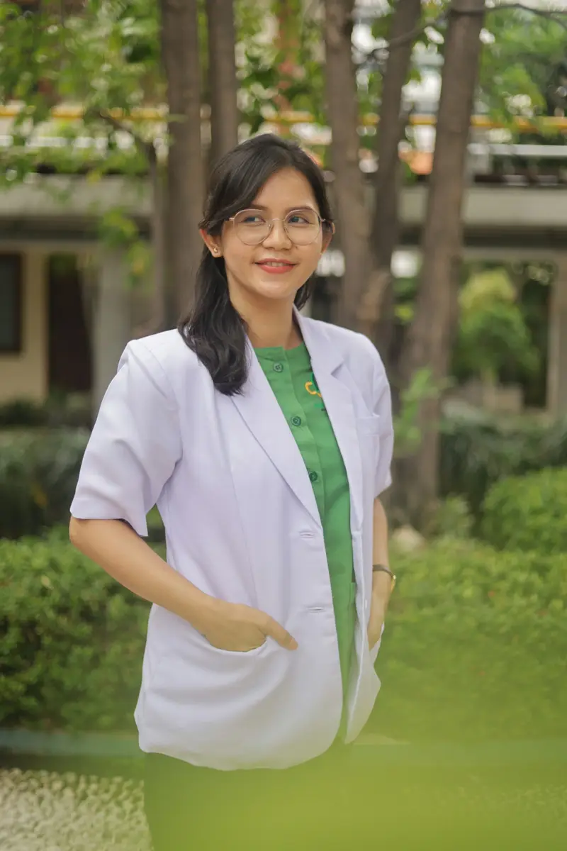 Portrait of a smiling woman doctor in a white coat