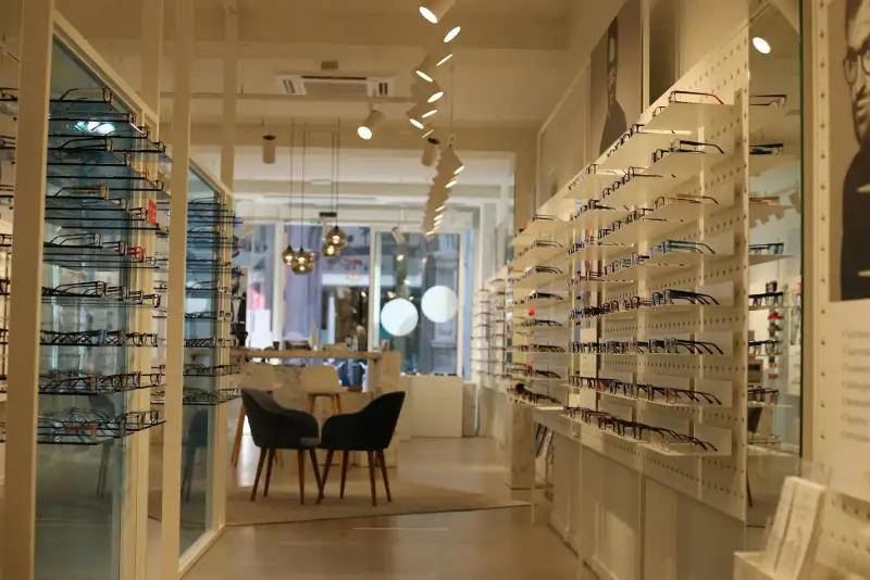 Modern optical store with frame walls and a fitting table