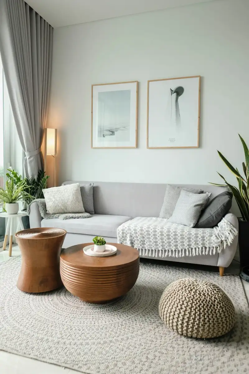 Bright living room with a grey sofa and solid-wood side tables