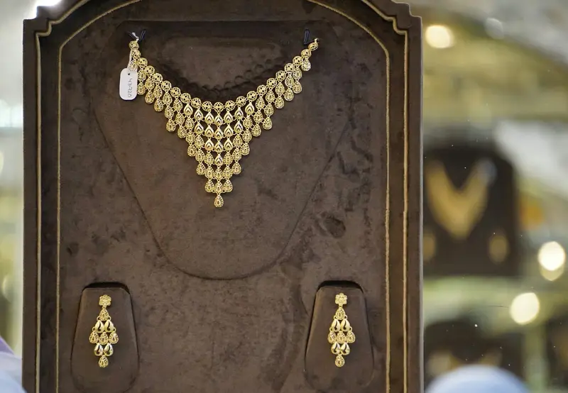 Gold necklace and earrings in a showroom display case