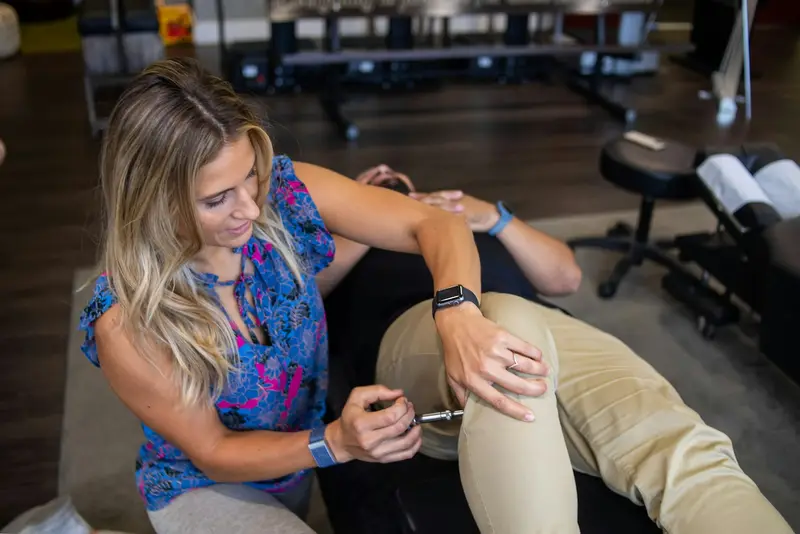 Physiotherapist checking a patient's knee
