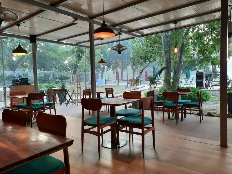Open-air garden seating with wooden tables