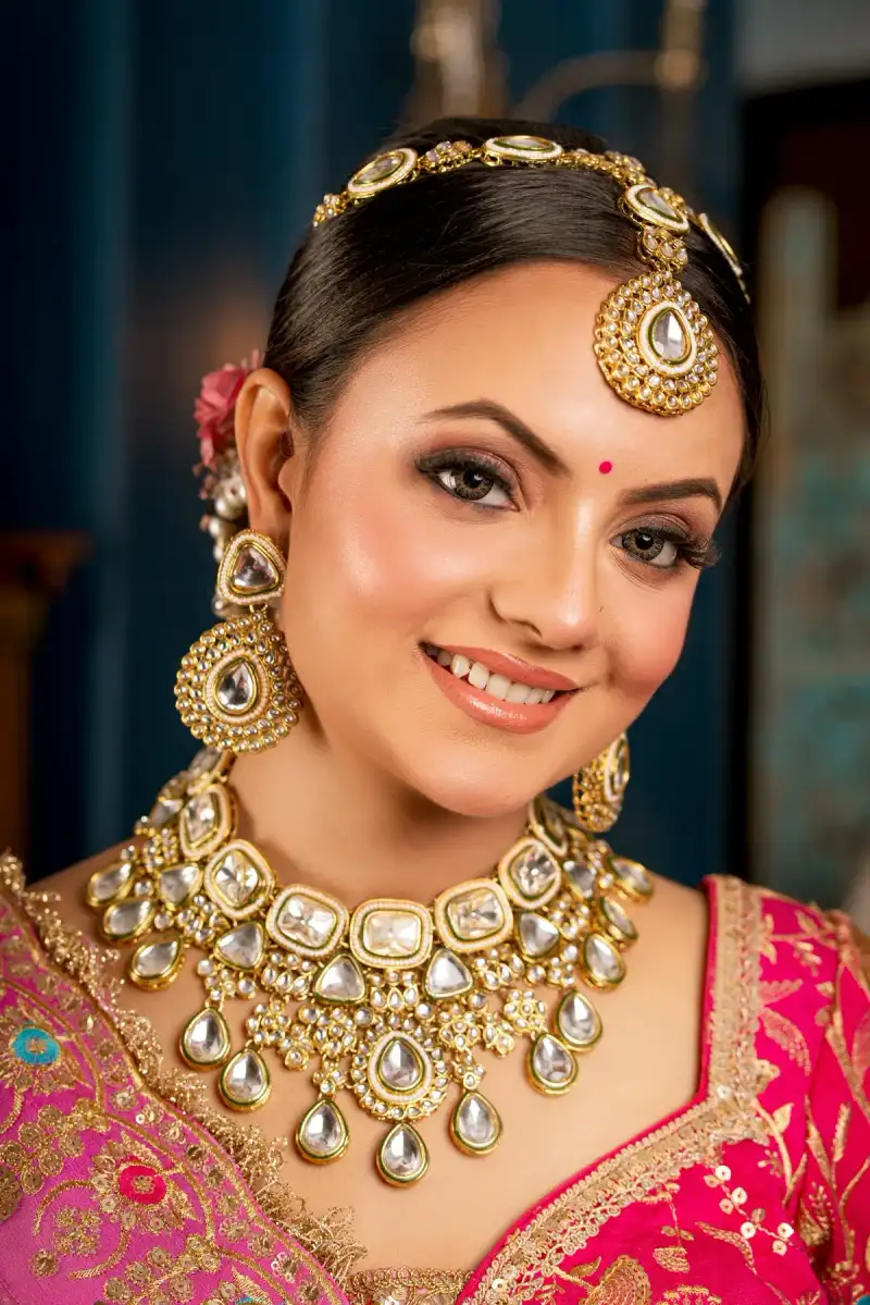 Smiling bride with bridal makeup and traditional gold jewellery